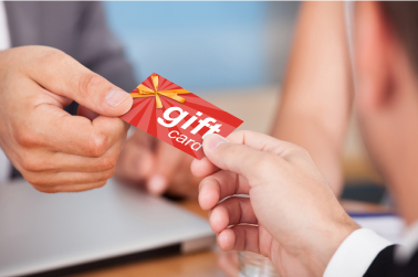 customer handing over a red gift card