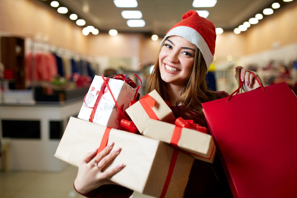 bigstock-Happy-Girl-Shopping-Gifts-In-M-268686241-1