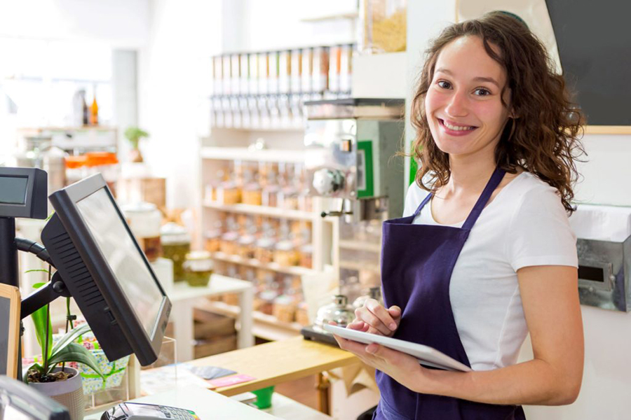 health-store-employee-smiling-at-checkout