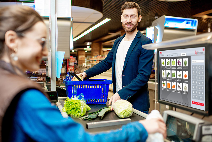 Handsome businessman putting products on the cash register buying food in the supermarket