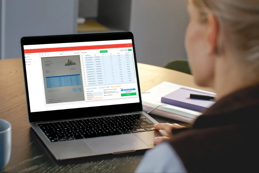 User reviewing AI Receiving data on a laptop with inventory and invoice processing software